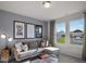 Cozy bedroom with a comfortable sofa, stylish decor, and a view of the outside at 741 Deschutes Dr, Garner, NC 27529