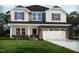 Charming two-story home featuring a brick facade, two-car garage, and freshly landscaped front yard at 741 Deschutes Dr, Garner, NC 27529