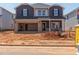 Two-story home with a two-car garage and brick and siding details at 741 Deschutes Dr, Garner, NC 27529