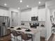 Spacious kitchen with stainless steel appliances, a center island, and modern white cabinetry at 741 Deschutes Dr, Garner, NC 27529