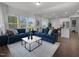Bright and airy living room featuring comfortable seating, large windows, and modern decor at 741 Deschutes Dr, Garner, NC 27529