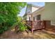 Home exterior showcasing a spacious deck with wooden railings and well-maintained lawn at 7705 Astoria Pl, Raleigh, NC 27612