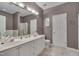 Bathroom features a dual sink vanity, ample countertop space, and a separate shower and tub at 7705 Astoria Pl, Raleigh, NC 27612