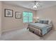 Bedroom featuring a comfortable bed, ceiling fan, and natural light from the window at 7705 Astoria Pl, Raleigh, NC 27612