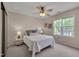 Comfortable bedroom with neutral tones, ceiling fan, and bright windows at 7705 Astoria Pl, Raleigh, NC 27612