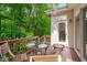 Inviting deck with glass table, fire pit, and wooded view perfect for outdoor relaxation and entertaining at 7705 Astoria Pl, Raleigh, NC 27612