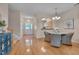 Open-concept dining area features hardwood floors, a view of the kitchen, and a staircase at 7705 Astoria Pl, Raleigh, NC 27612