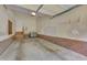 Spacious two-car garage with ample storage, brick base, and access door to home at 7705 Astoria Pl, Raleigh, NC 27612