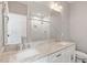 Bathroom featuring a double sink vanity, marble counters, chrome fixtures, and large mirror and walk in shower at 811 E Lane St, Raleigh, NC 27601