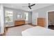 Bedroom with hard wood floors, light gray walls, bright windows and modern dressers with light gray area rug at 811 E Lane St, Raleigh, NC 27601