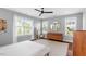 Bedroom featuring a bed with white linens, hard wood floors, a light gray area rug, bright windows and a dresser at 811 E Lane St, Raleigh, NC 27601