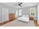 Bedroom featuring a ceiling fan, a bed with white linens, hard wood floors, and a light gray area rug at 811 E Lane St, Raleigh, NC 27601