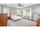 Bedroom featuring a ceiling fan, a bed with white linens, hard wood floors, and a light gray area rug at 811 E Lane St, Raleigh, NC 27601