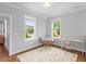 Bedroom with light gray walls, hard wood floors, a bright window and a small desk and chair at 811 E Lane St, Raleigh, NC 27601