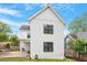 Exterior view of the home with white siding, black-trimmed windows, and a wooden deck at 811 E Lane St, Raleigh, NC 27601