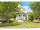 Charming home with a welcoming front porch framed by lush greenery and a stone walkway at 811 E Lane St, Raleigh, NC 27601