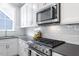 Updated kitchen with stainless steel appliances, white subway tile backsplash, and ample counter space at 811 E Lane St, Raleigh, NC 27601