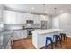 Beautiful kitchen with white cabinets, stainless steel appliances and an island with seating at 811 E Lane St, Raleigh, NC 27601
