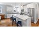 Bright kitchen featuring a large island, white cabinets, stainless steel appliances, and hardwood floors at 811 E Lane St, Raleigh, NC 27601