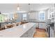 Open-concept kitchen with quartz countertops, island seating, and stainless steel appliances at 811 E Lane St, Raleigh, NC 27601
