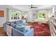 Bright living room with large windows, comfortable seating and a decorative red rug at 811 E Lane St, Raleigh, NC 27601