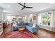 Bright, open-concept living room with a modern ceiling fan and a blue sectional sofa at 811 E Lane St, Raleigh, NC 27601