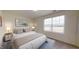 Bright bedroom featuring neutral walls, carpeted floors, a large window, and furnishings with modern lamps at 914 Bombardier Aly, Spring Hope, NC 27882