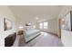 Bright primary bedroom features neutral walls, carpeted floors, two large windows, and modern furnishings at 914 Bombardier Aly, Spring Hope, NC 27882