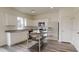 Bright kitchen featuring white cabinetry, stainless steel appliances, a movable island, and wood plank flooring at 914 Bombardier Aly, Spring Hope, NC 27882