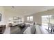 Bright living room features lots of seating, neutral walls, and dark wood plank flooring with a large area rug at 914 Bombardier Aly, Spring Hope, NC 27882