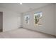 Cozy bedroom with plush carpet and two windows providing natural light at 944 Bombardier Ln, Spring Hope, NC 27882