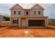 New construction home with an attached garage and traditional design awaits landscaping at 944 Bombardier Ln, Spring Hope, NC 27882
