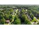 An aerial view of a neighborhood showcasing lush greenery and mature trees at 1005 Stuart Dr, Mebane, NC 27302