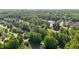 An overhead shot captures a residential area nestled among mature trees, highlighting community and natural beauty at 1005 Stuart Dr, Mebane, NC 27302