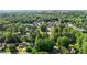 An aerial view of a tranquil neighborhood surrounded by lush forests at 1005 Stuart Dr, Mebane, NC 27302