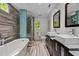 Luxurious bathroom with double vanity, soaking tub and a glass walk-in shower featuring unique tile design at 1005 Stuart Dr, Mebane, NC 27302