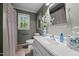 Bathroom with a single vanity and combination shower and tub with a window for natural light at 1005 Stuart Dr, Mebane, NC 27302
