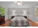Primary bedroom featuring hardwood floors, natural light, ensuite bathroom, and neutral paint at 1005 Stuart Dr, Mebane, NC 27302