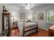 Bedroom with hardwood floors, natural light, and traditional furnishings, creating a cozy and inviting space at 1005 Stuart Dr, Mebane, NC 27302