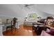 Spacious bedroom with hardwood floors, ceiling fan, plush recliner, and a glass-top desk perfect for working at 1005 Stuart Dr, Mebane, NC 27302