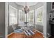 Charming breakfast nook with lots of windows and a glass top table at 1005 Stuart Dr, Mebane, NC 27302