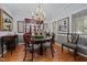 Elegant dining room with hardwood floors, chandelier, and traditional decor at 1005 Stuart Dr, Mebane, NC 27302