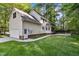 Home exterior with a brick foundation, attached garage, a patio, a deck, and a well manicured lawn at 1005 Stuart Dr, Mebane, NC 27302