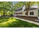 Traditional two-story house boasts a large front yard, expansive porch, and mature trees at 1005 Stuart Dr, Mebane, NC 27302