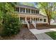 Charming two-story home featuring a welcoming front porch, manicured landscaping, and classic black shutters at 1005 Stuart Dr, Mebane, NC 27302
