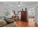 Bright home office featuring hardwood floors, natural light, and an adjacent doorway to a bedroom at 1005 Stuart Dr, Mebane, NC 27302