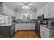 Well-lit kitchen featuring white cabinets, stainless appliances, and granite countertops at 1005 Stuart Dr, Mebane, NC 27302