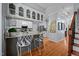 Open kitchen with white cabinets, stainless steel appliances, and breakfast bar seating at 1005 Stuart Dr, Mebane, NC 27302