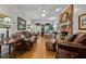 Cozy living room with hardwood floors, brick fireplace, and plush seating arrangements at 1005 Stuart Dr, Mebane, NC 27302