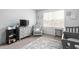 Bright Bedroom features a rocking chair, dresser with TV, and a patterned rug at 1009 Haynoke Dr, Graham, NC 27253
